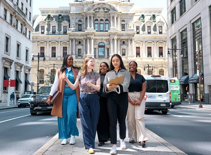 Five Dornsife students chatting in front of Philadelphia City Hall